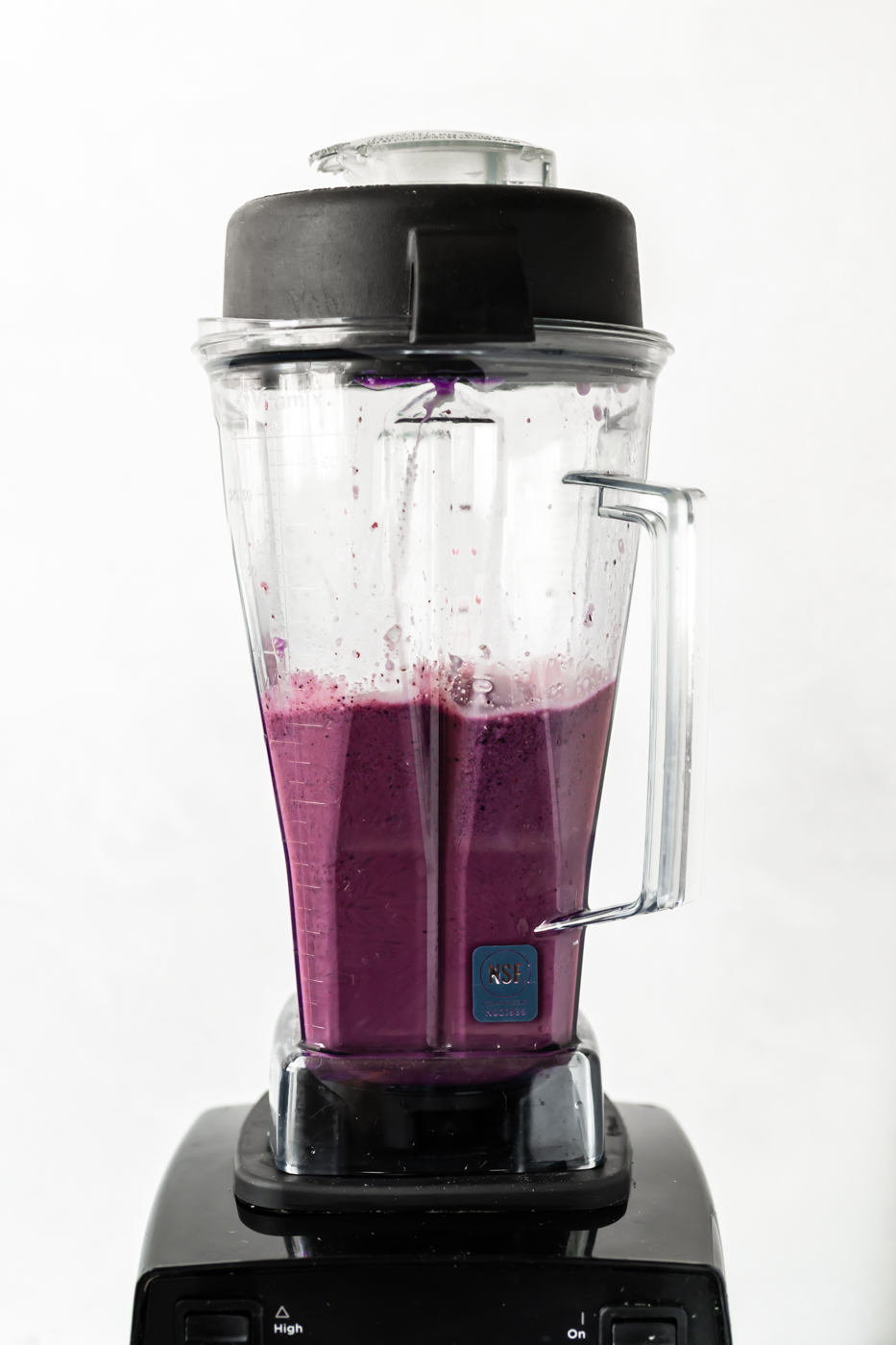 A blueberry coconut milk smoothie being blended up in a Vitamix blender.