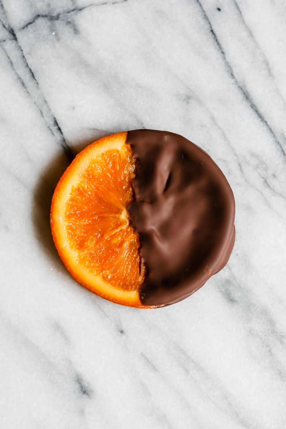 A single chocolate dipped candied orange