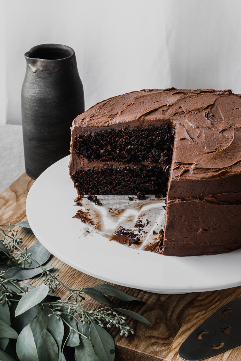 Up close, the cake has been sliced into and you can see a layer of rich chocolate fudge icing in between the chocolate cake.